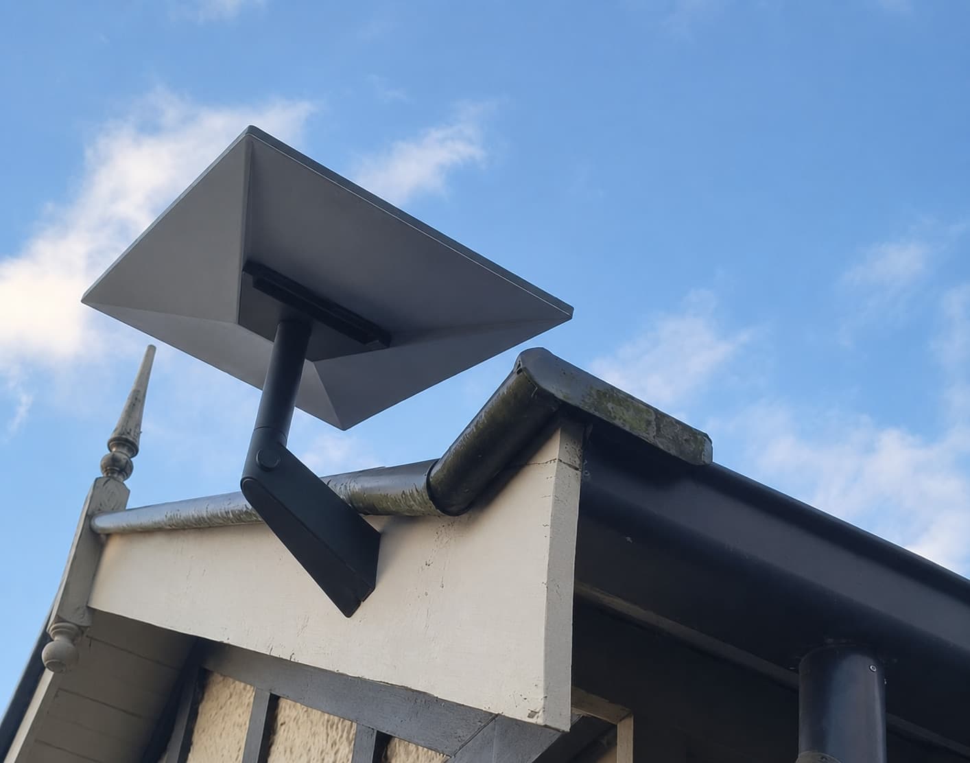 Starlink dish on a fascia mount under the roof edge