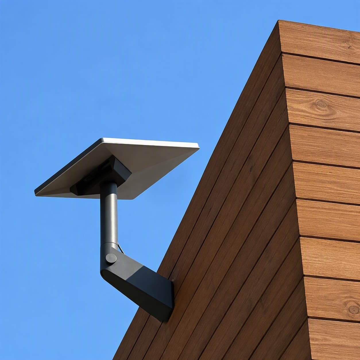 Starlink dish mounted on a timber wall face